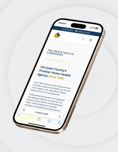 A smartphone displaying the Basin Health Companies mobile website, highlighting their role as San Juan County’s premier home health agency since 1992. The screen shows contact information, branding, and a brief description of services.