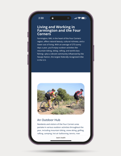 Two cyclists ride mountain bikes on a dirt trail surrounded by desert shrubs and trees in Farmington, New Mexico, highlighting the region’s outdoor recreation opportunities.
